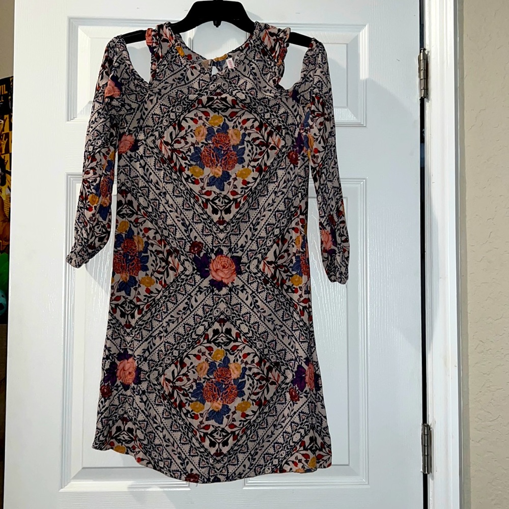 Cream dress with multi color floral design.